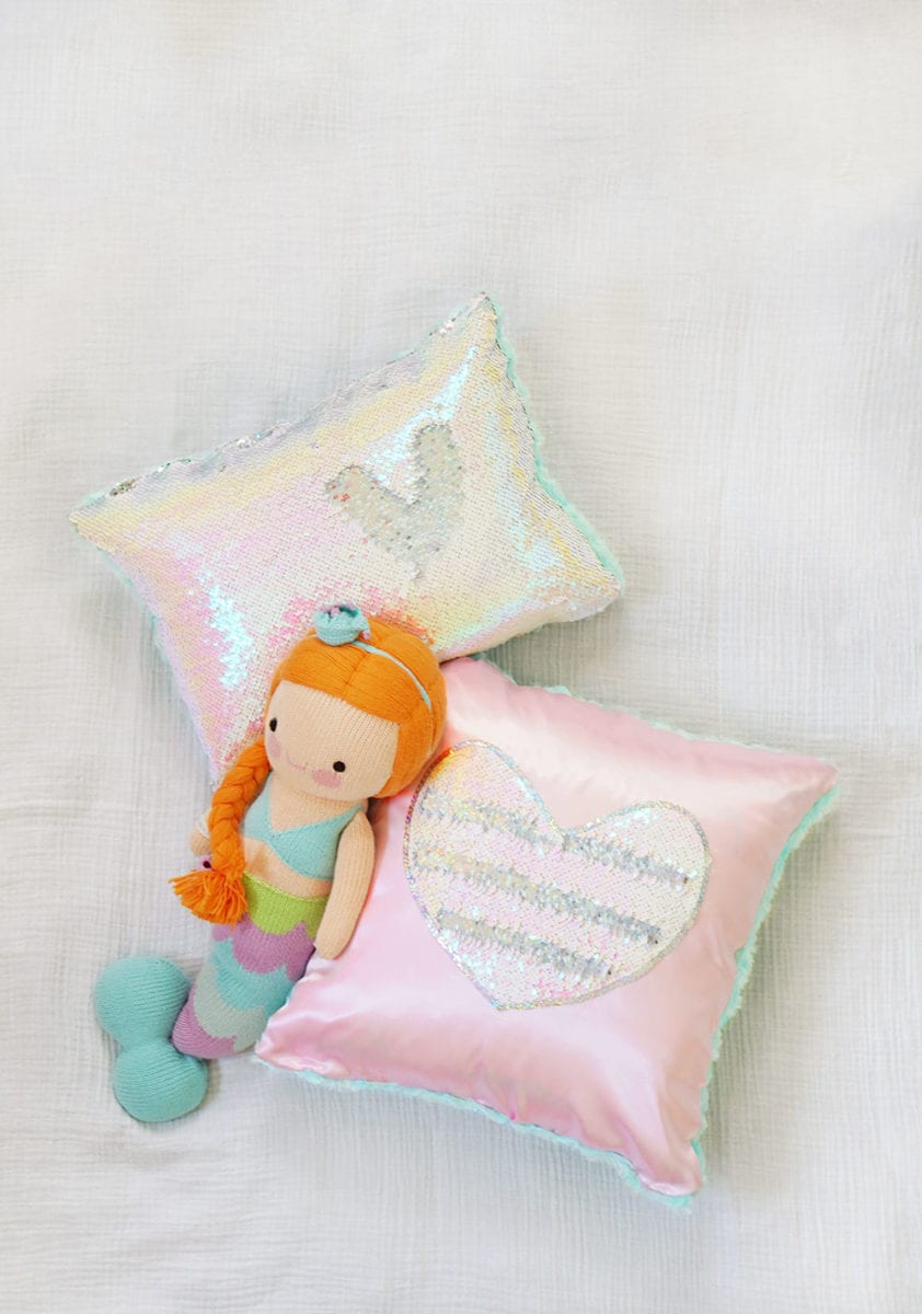 Pink heart magic sequin pillow and iridescent mermaid sequin pillow with Cuddle and Kind Isla mermaid doll