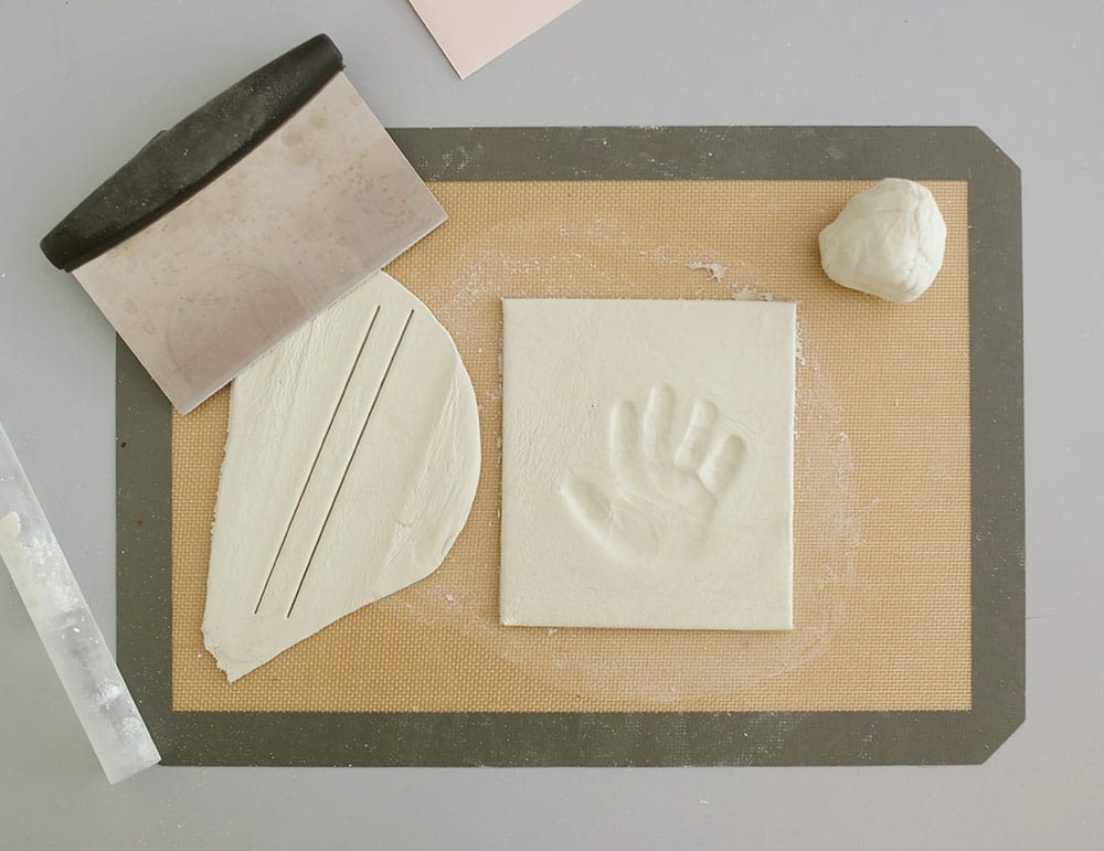 Air dry clay on a silicone baking mat to make a diy baby clay handprint keepsake frame
