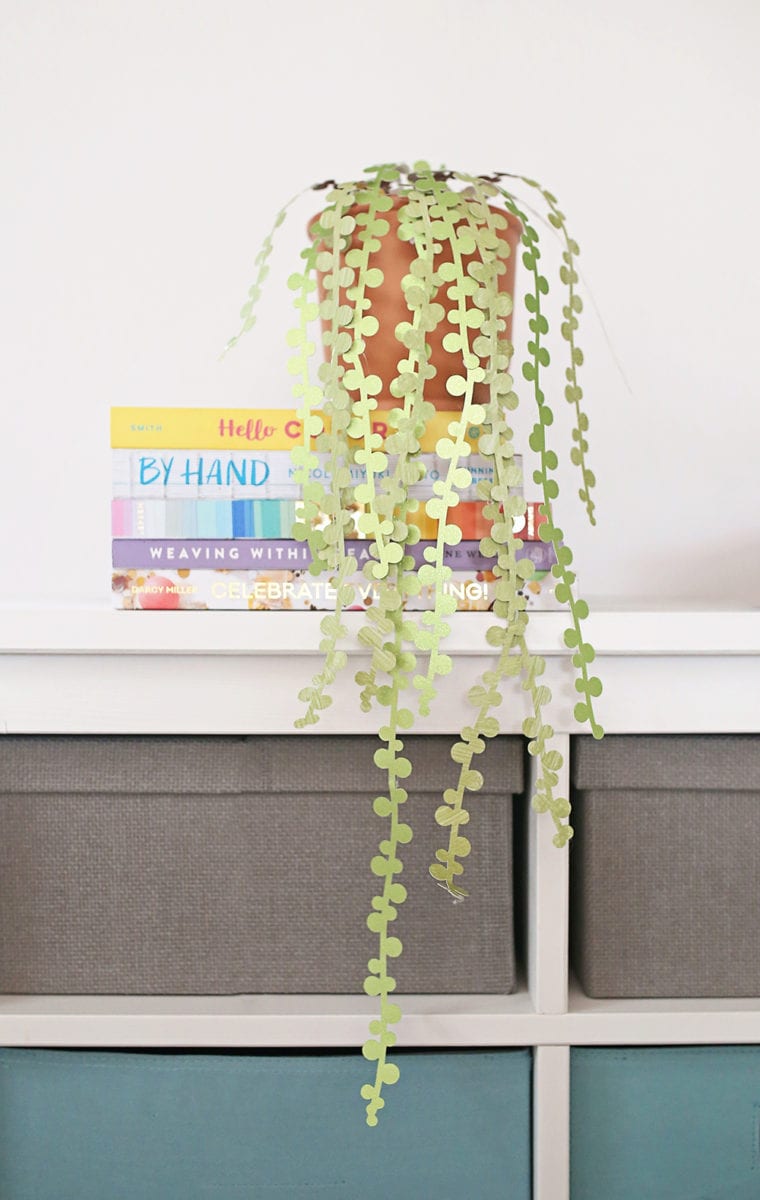 String of pearls DIY paper succulents in a terra cotta pot against a white wall