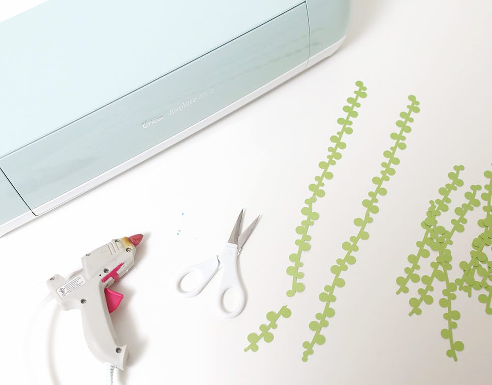 Mint Cricut machine on a white desk