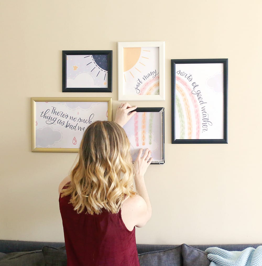 Woman with blonde ombre balayage hair puts a SnapeZo frame on a gallery wall