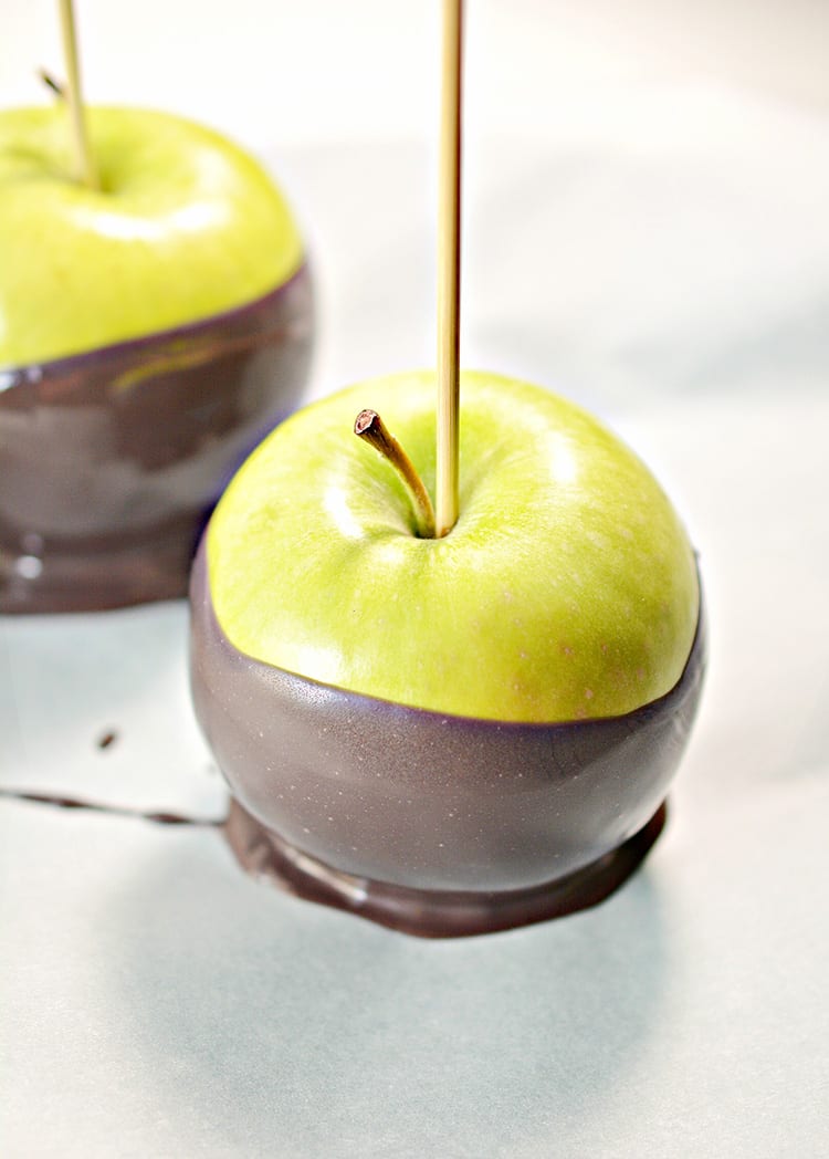 Green apples dipped in black chocolate to make poison apples for a Halloween party