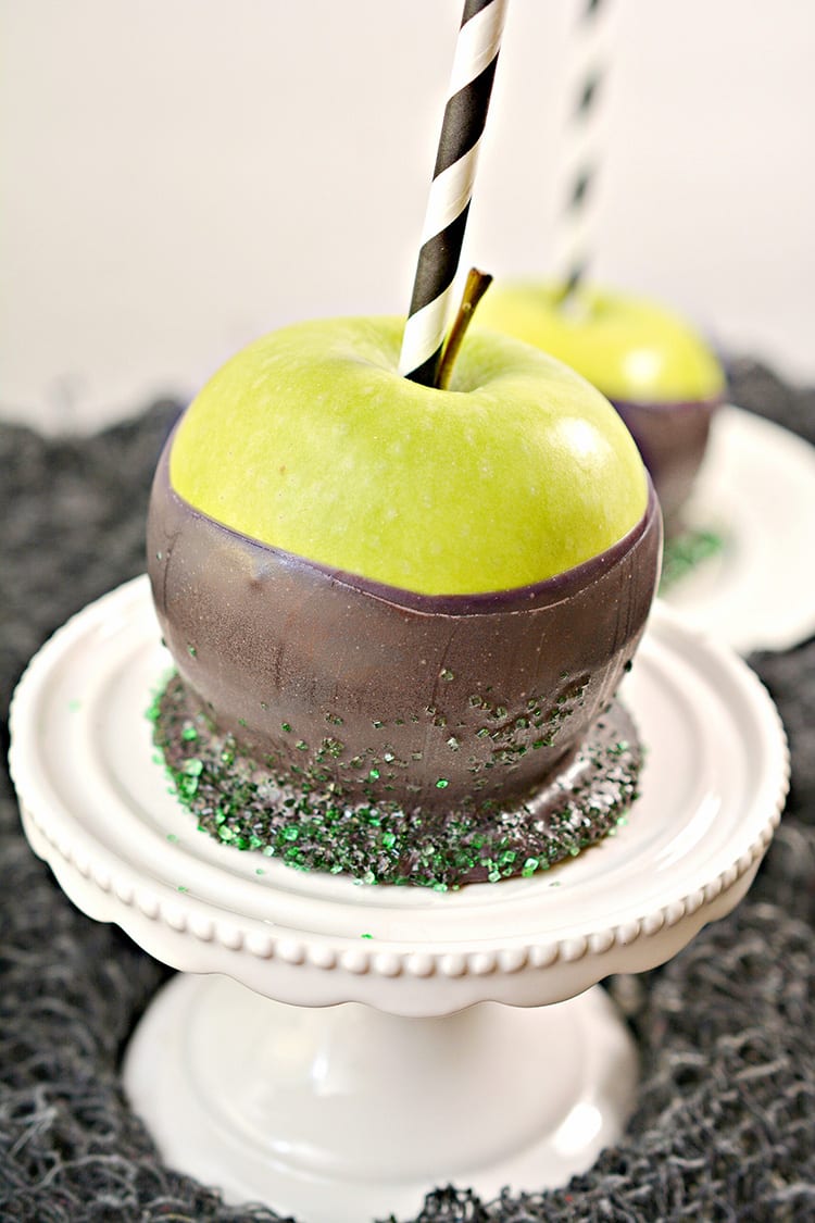 Green apples dipped in black chocolate to make poison apples for a Halloween party