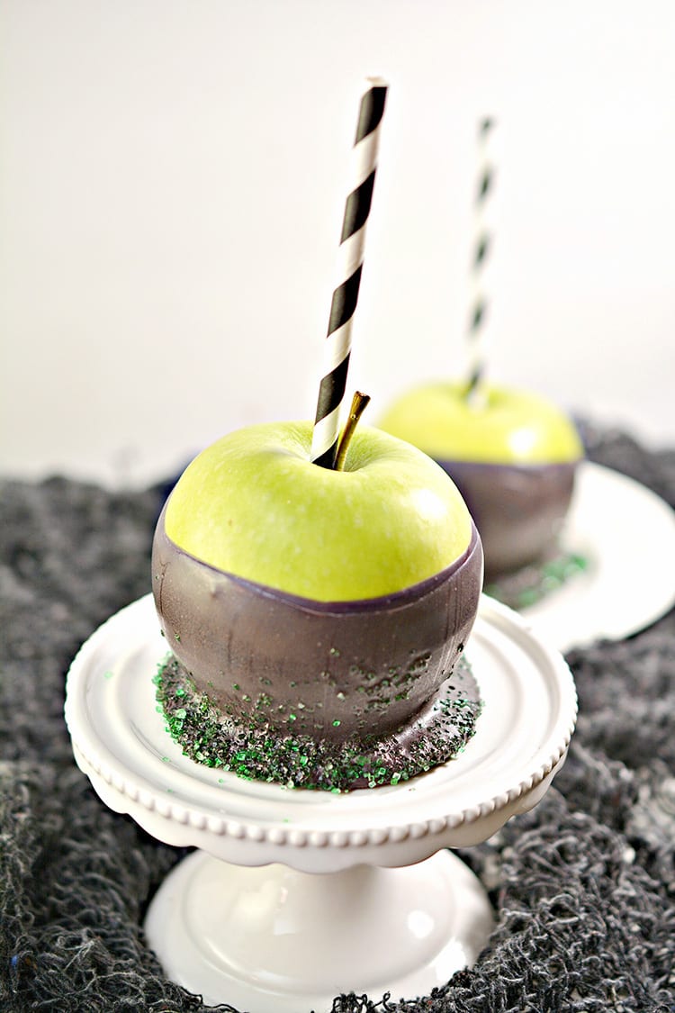 Green apples dipped in black chocolate to make poison apples for a Halloween party