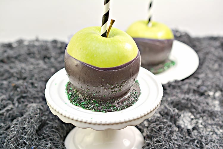 Green apples dipped in black chocolate to make poison apples for a Halloween party