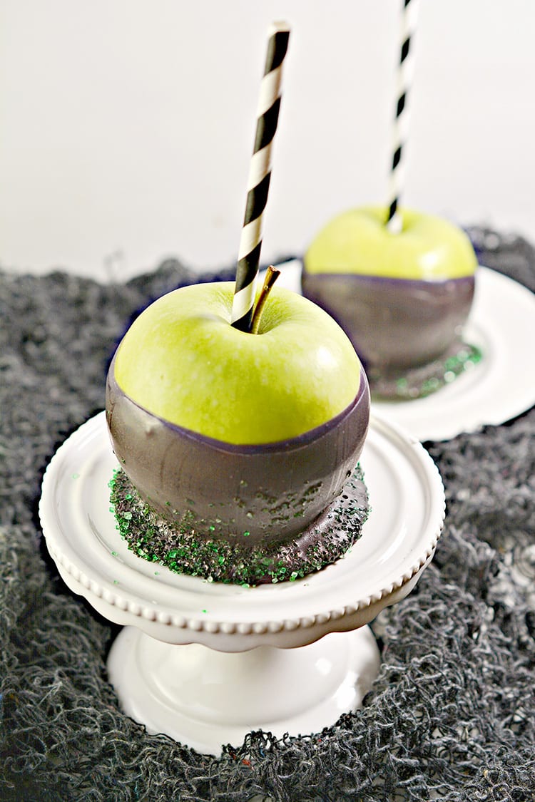 Green apples dipped in black chocolate to make poison apples for a Halloween party