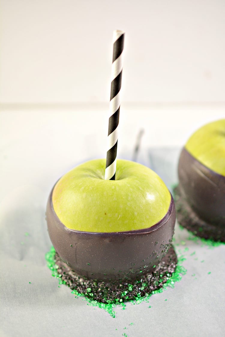 Green apples dipped in black chocolate to make poison apples for a Halloween party