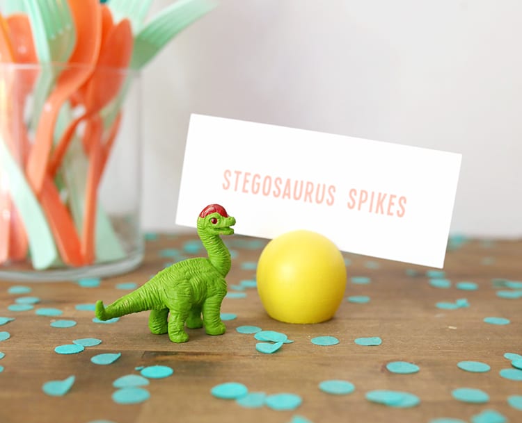 Toy dinosaur and a yellow wooden DIY place card holder