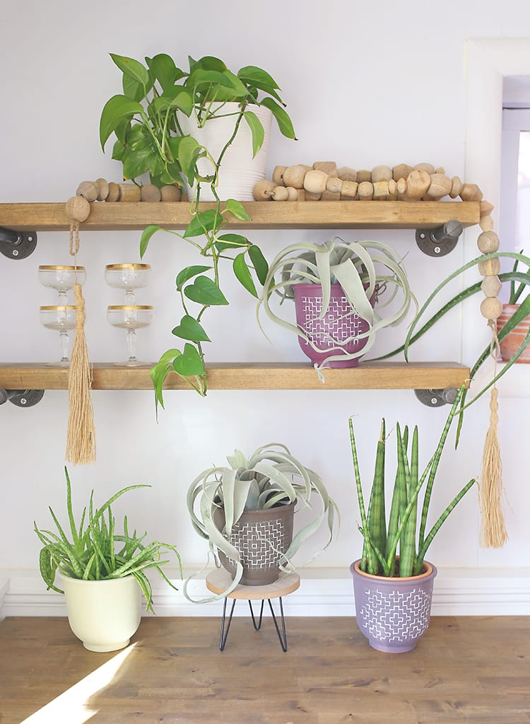 Looking for modern DIY painted terra cotta pots ideas? This boho painted pot idea with acrylic paint uses fun, simple geometric design inspired by sashiko embroidery patterns.