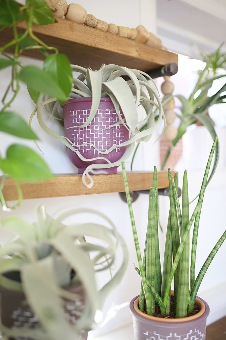 Looking for modern DIY painted terra cotta pots ideas? This boho painted pot idea with acrylic paint uses fun, simple geometric design inspired by sashiko embroidery patterns.