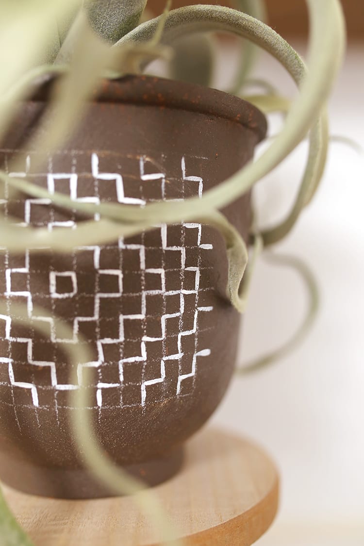 Looking for modern DIY painted terra cotta pots ideas? This boho painted pot idea with acrylic paint uses fun, simple geometric design inspired by sashiko embroidery patterns.