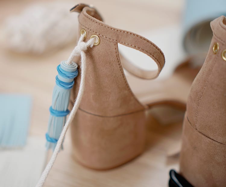 Tutorial: Learn how to make DIY leather tassel shoes, purse, or keyring. These faux leather tassels are perfect for jewelry ideas or to make a vegan leather necklace charm or home decor accessory out of marine vinyl fabric. No sewing required, since you glue instead of sew! They're easy enough to make with kids if you're looking for crafts to make together!