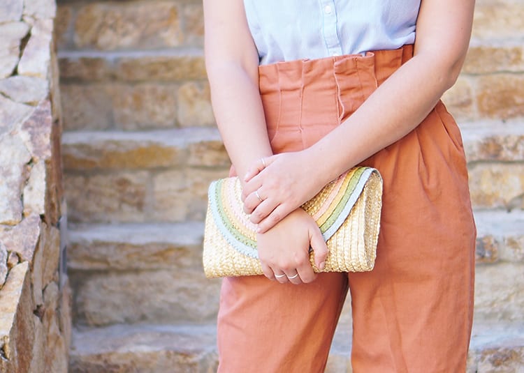 DIY a half-round straw purse for summer with this adorable rainbow clutch tutorial using regular old acrylic paint! It's ridiculously easy and can be made in a classic bright rainbow or this pretty pastel color palette for spring and summer!