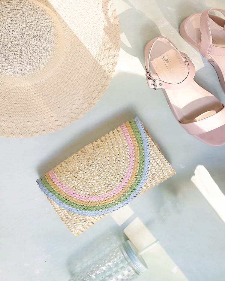 DIY a half-round straw purse for summer with this adorable rainbow clutch tutorial using regular old acrylic paint! It's ridiculously easy and can be made in a classic bright rainbow or this pretty pastel color palette for spring and summer!