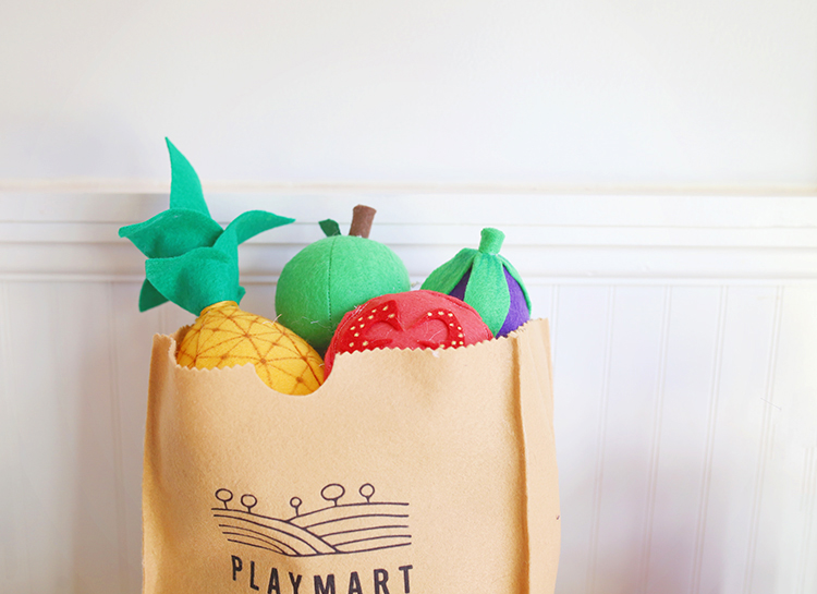 Felt fruit and vegetables and a DIY play grocery bag that looks like a brown paper bag