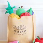 Felt fruit and vegetables and a DIY play grocery bag that looks like a brown paper bag
