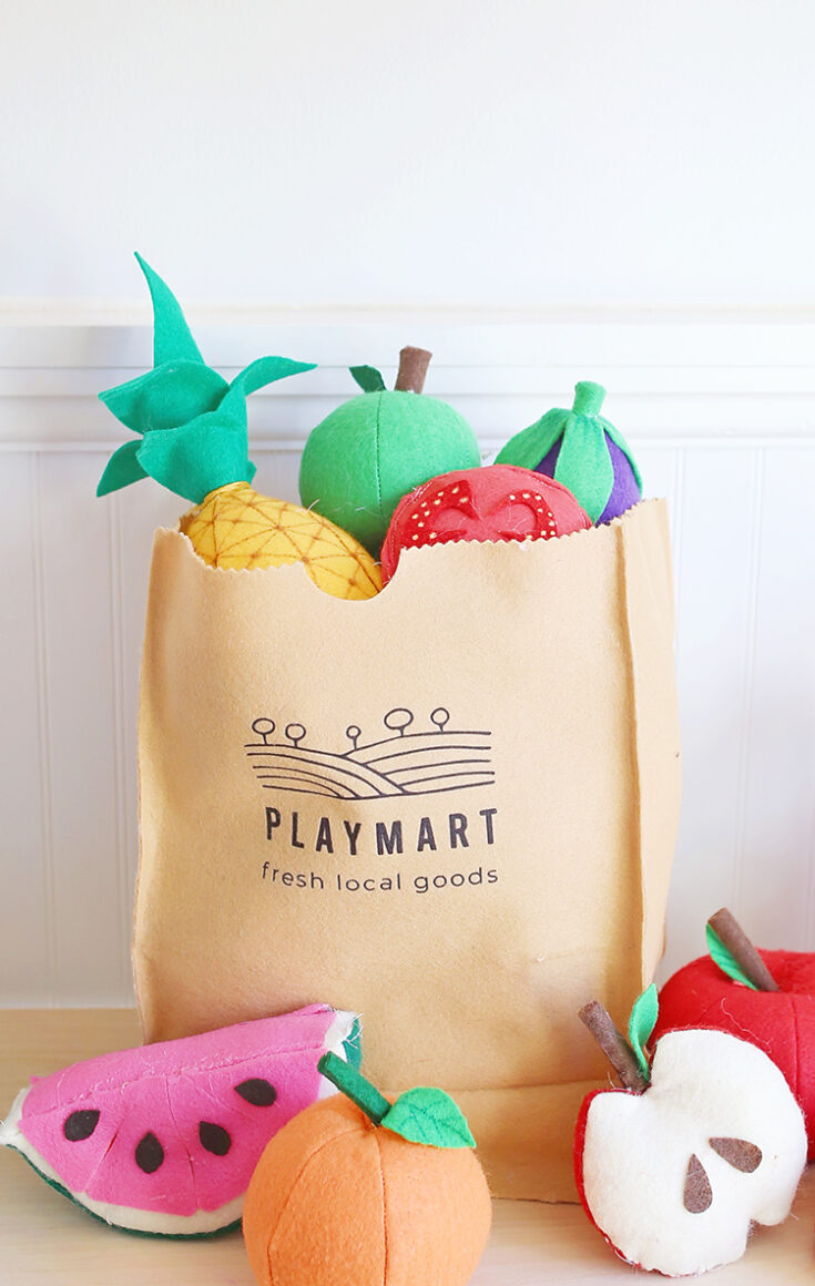 Felt fruit and vegetables and a DIY play grocery bag that looks like a brown paper bag