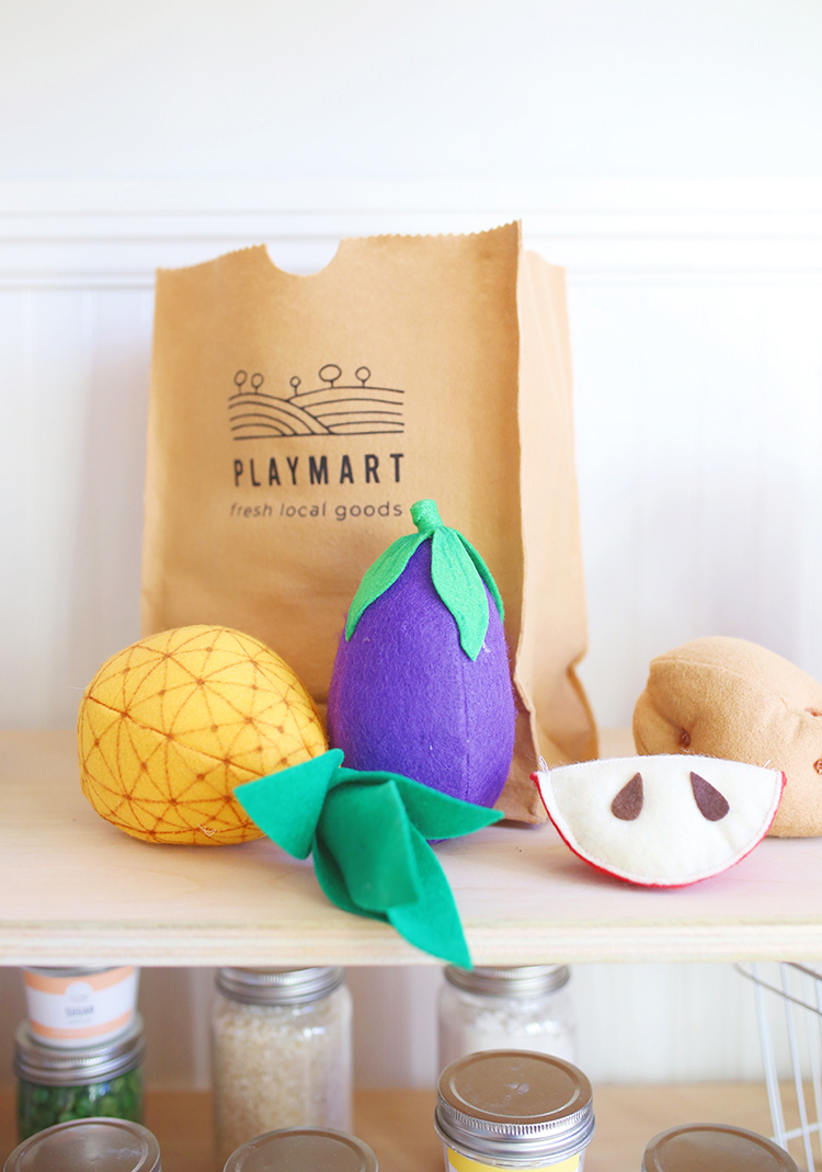 Felt fruit and vegetables and a DIY play grocery bag that looks like a brown paper bag